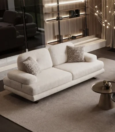 A stationary modern textured fabric sofa featuring fine linear tufted backrest detailing, soft rounded armrests, and elegant slender support legs, shown in a high-ceiling luxury living room.