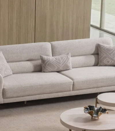 Lina Three Seater Sofa featuring distinct armrest accents, metallic leg details, and a spacious seat cushion layout.