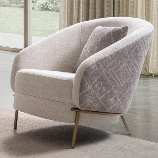 Lina Armchair featuring a curved barrel-style backrest, patterned outer upholstery, and slim metal legs.