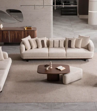 Sola Sofa Set featuring two curved modern sofas and a matching armchair arranged around a coffee table in a spacious living room.