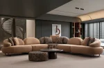Tolia Corner Sofa - 5 Modules five-piece modular curved corner sofa featuring warm beige seating, patterned accent cushions, and an integrated wooden console table.