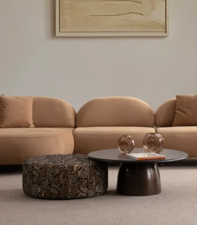 Tolia Chaise Corner Sofa - 3 Module three-piece modular curved sofa featuring an extended chaise end, warm beige upholstery, and plush decorative cushions.