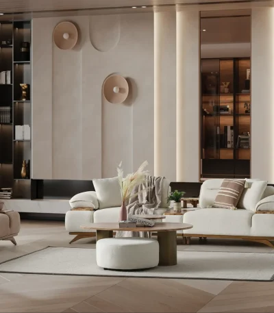 A modern living room featuring the Grace Sofa. The arrangement displays a plush taupe sofa and a matching cream sofa, both designed with distinctive integrated wooden side tables on the armrests and angled wooden legs. A white swivel armchair and a round wooden coffee table complete the cozy, contemporary look of this furniture from Turkey.