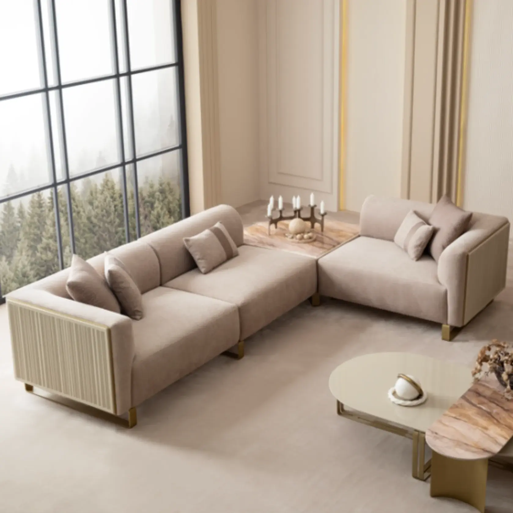Grandeur-Corner-Sofa-Module-01 A luxurious modular Grandeur sofa set in a bright, modern living room. The set features cream-colored fabric upholstery with rectangular cushions and sleek gold metallic legs. Beside the modular sections sits a matching rounded armchair with gold accents. The scene includes minimalist decor, a marble coffee table, and large windows, highlighting the elegant design of the Grandeur furniture from Turkey.