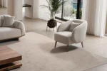 Laos Armchair - Minimalist rounded boucle accent chair with tapered wooden legs.
