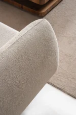 Modern rounded sofa with white boucle fabric and wooden base, luxury turkish furniture.