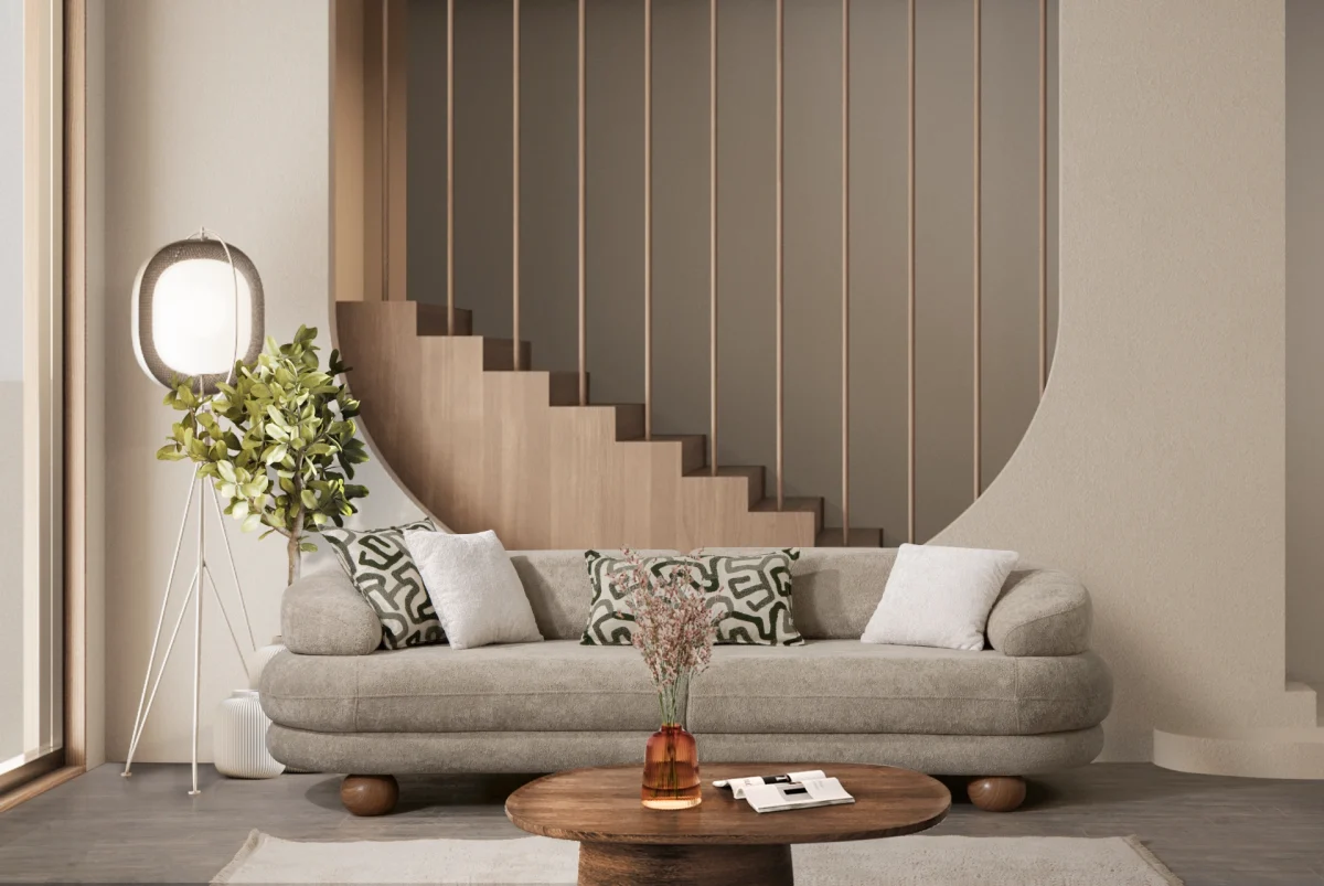 Premium sand grey curved sofa with sculptural round wooden legs and decorative cushions