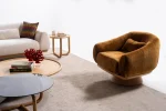 The Thalia Armchair offers a sophisticated seating experience, wrapped in rich, tactile fabric. Its base and seat create the perfect reading nook or decorative piece.