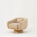 The Thalia Armchair offers a sophisticated seating experience, wrapped in rich, tactile fabric. Its base and seat create the perfect reading nook or decorative piece.