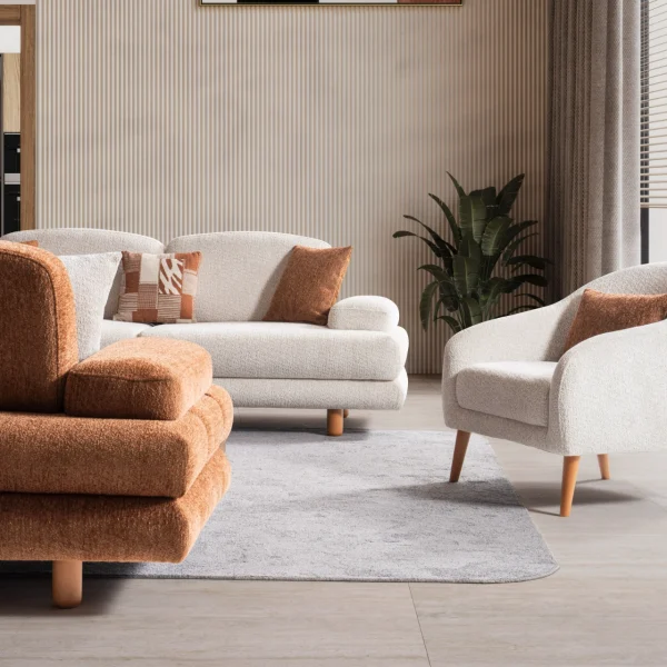 A harmonized Troyas sofa set showcasing a visual dialogue between warm terracotta and ivory tones, featuring matching organic curved silhouettes in a luxury contemporary setting – SofaTurkey.