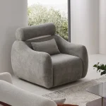 The vibrant Amora Armchair featuring textured white, orange, and grey seating in a bright, modern minimalist room, designed to create an energetic and artistic atmosphere.