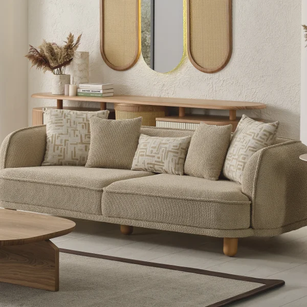 The organic Areon Sofa featuring textured fabric and wooden legs, placed in a bright, minimalist living room that evokes a sense of natural harmony and peace.