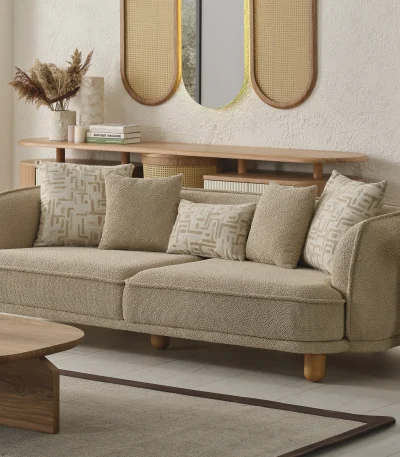 The organic Areon Sofa featuring textured fabric and wooden legs, placed in a bright, minimalist living room that evokes a sense of natural harmony and peace.