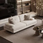 A stationary modern textured fabric sofa featuring fine linear tufted backrest detailing, soft rounded armrests, and elegant slender support legs, shown in a high-ceiling luxury living room.