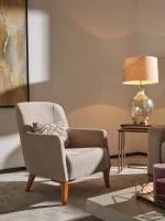 Bria Armchair featuring a high-back upholstered design, comfortable throw cushion, and tapered wooden legs.
