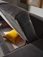 Bria Corner Sofa modern charcoal grey sectional sofa featuring quilted outer armrests, colorful throw pillows, and wooden legs.