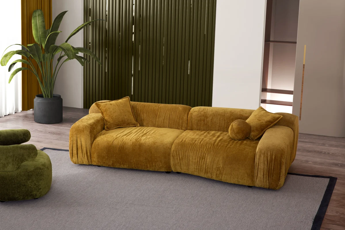 The Rio Sofa set featuring a deep-seated mustard yellow sofa and a matching forest green sofa with plush corduroy-style texture, complemented by a unique curved green armchair in a bright, modern penthouse.