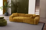 The Rio Sofa set featuring a deep-seated mustard yellow sofa and a matching forest green sofa with plush corduroy-style texture, complemented by a unique curved green armchair in a bright, modern penthouse.