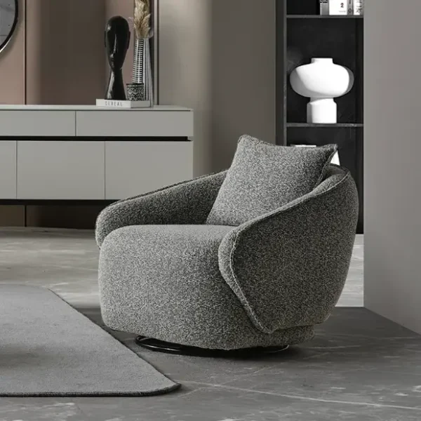 The elite Coaley Armchair featuring grey textured upholstery and sleek black legs, arranged in a high-end, modern living room that embodies a prestigious and balanced lifestyle.