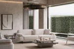 Cora Sofa styled in a modern interior setting with curved armrests and a wide seating surface.