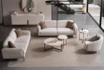 Elora Set Sofa featuring modern mechanism sofas and a tub-style armchair arranged in a spacious living room setting.