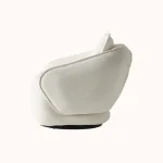 A modern living room featuring the Grace Sofa. The arrangement displays a plush taupe sofa and a matching cream sofa, both designed with distinctive integrated wooden side tables on the armrests and angled wooden legs. A white swivel armchair and a round wooden coffee table complete the cozy, contemporary look of this furniture from Turkey.