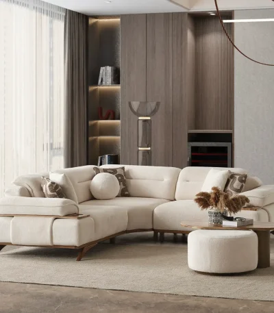 A modern living room featuring the Grace Sofa. The arrangement displays a plush taupe sofa and a matching cream sofa, both designed with distinctive integrated wooden side tables on the armrests and angled wooden legs. A white swivel armchair and a round wooden coffee table complete the cozy, contemporary look of this furniture from Turkey.