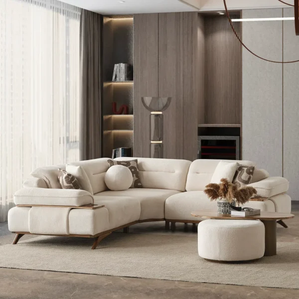 A modern living room featuring the Grace Sofa. The arrangement displays a plush taupe sofa and a matching cream sofa, both designed with distinctive integrated wooden side tables on the armrests and angled wooden legs. A white swivel armchair and a round wooden coffee table complete the cozy, contemporary look of this furniture from Turkey.