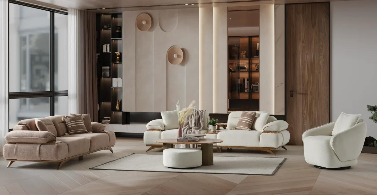 A modern living room featuring the Grace Sofa. The arrangement displays a plush taupe sofa and a matching cream sofa, both designed with distinctive integrated wooden side tables on the armrests and angled wooden legs. A white swivel armchair and a round wooden coffee table complete the cozy, contemporary look of this furniture from Turkey.