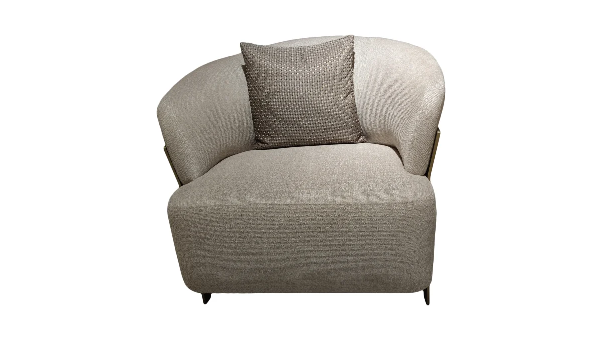 A luxurious modular Grandeur sofa set in a bright, modern living room. The set features cream-colored fabric upholstery with rectangular cushions and sleek gold metallic legs. Beside the modular sections sits a matching rounded armchair with gold accents. The scene includes minimalist decor, a marble coffee table, and large windows, highlighting the elegant design of the Grandeur furniture from Turkey.