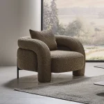 The distinguished Harmoni Armchair in a bright, modern interior with curved architectural details and warm brown accents, embodying a sense of balance and harmony.