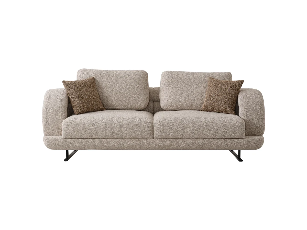 The refined Harmoni Sofa in a clean, modern setting, featuring soft curved forms, light bouclé upholstery, and subtle warm brown cushions that emphasize balance and harmony.