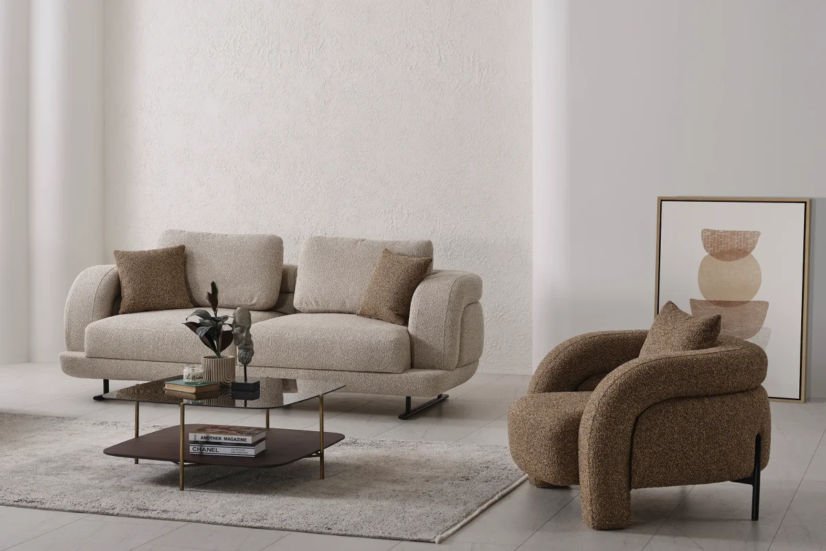 Modern fabric sofa set with rounded design, beige three-seater sofa and brown armchair, black metal legs, contemporary living room setting