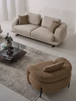 Modern fabric sofa set with rounded design, beige three-seater sofa and brown armchair, black metal legs, contemporary living room setting