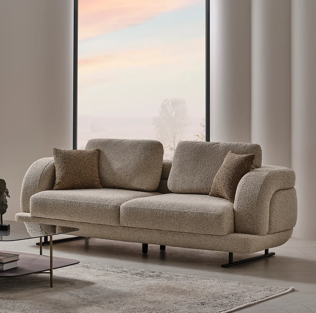 Harmoni Sofa Duo Set - SofaTurkey modern sofa set, compact sofa set, sofa duo, fabric sofa europe, contemporary seating, sofa set from turkey-4 The distinguished Harmoni Sofa in a bright, modern interior with curved architectural details and warm brown accents, embodying a sense of balance and harmony.