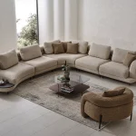 Harmoni Corner Sofa Prime Lounge Soft Trio Set featuring a large curved modular sofa in cream, paired with a matching accent chair, modern interior.