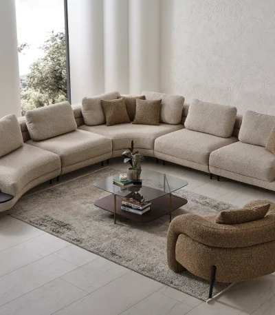 Harmoni Corner Sofa Prime Lounge Soft Trio Set featuring a large curved modular sofa in cream, paired with a matching accent chair, modern interior.