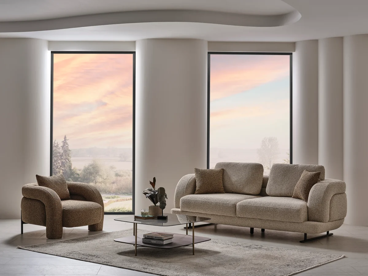 Modern fabric sofa set with rounded design, beige three-seater sofa and brown armchair, black metal legs, contemporary living room setting