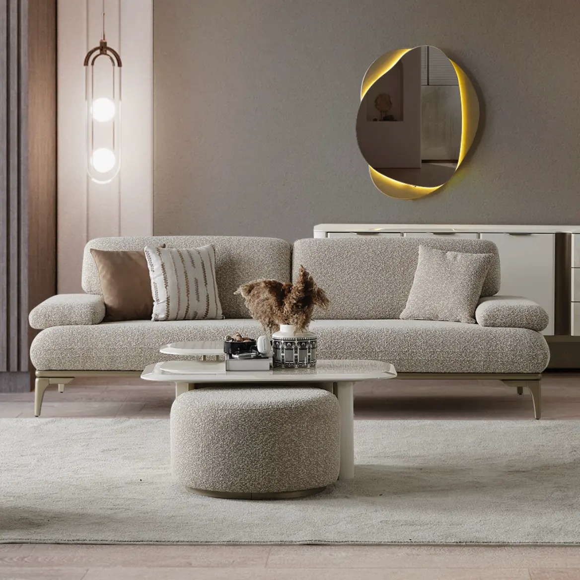 Horizon-Sofa-Modern-Luxury-Sofas-From-Turkey-1 A modern Horizon Sofa set arranged in a chic living room. The furniture features textured grey upholstery with distinctive folded armrests and sleek champagne gold metallic legs. A matching round swivel armchair and a white coffee table with a cylindrical pouf complete the contemporary Turkish furniture ensemble.