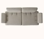 A modern Horizon Sofa set arranged in a chic living room. The furniture features textured grey upholstery with distinctive folded armrests and sleek champagne gold metallic legs. A matching round swivel armchair and a white coffee table with a cylindrical pouf complete the contemporary Turkish furniture ensemble.