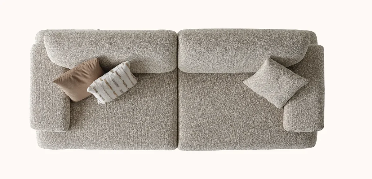 A modern Horizon Sofa set arranged in a chic living room. The furniture features textured grey upholstery with distinctive folded armrests and sleek champagne gold metallic legs. A matching round swivel armchair and a white coffee table with a cylindrical pouf complete the contemporary Turkish furniture ensemble.