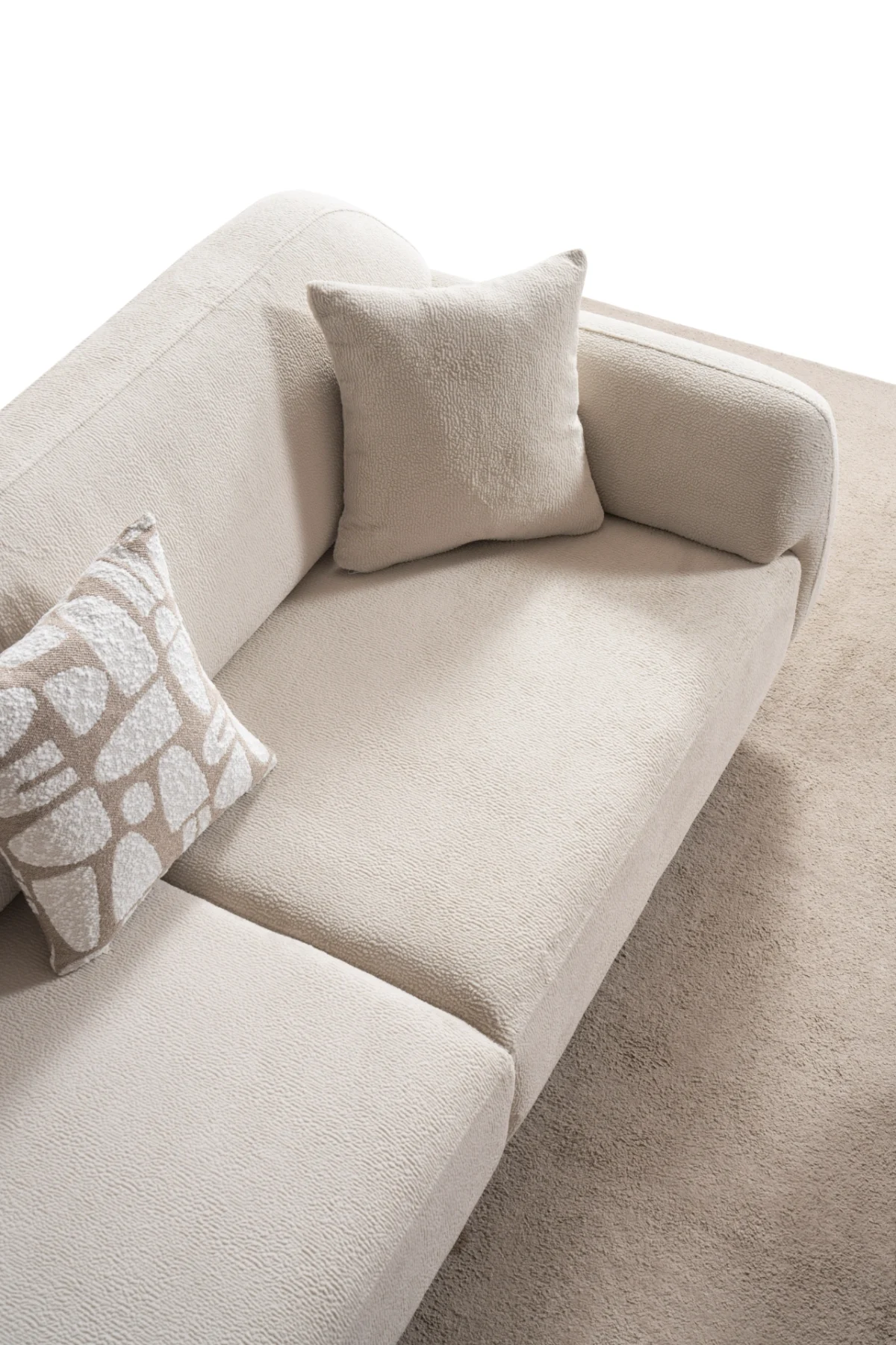 Modern rounded sofa with white boucle fabric and wooden base, luxury turkish furniture.