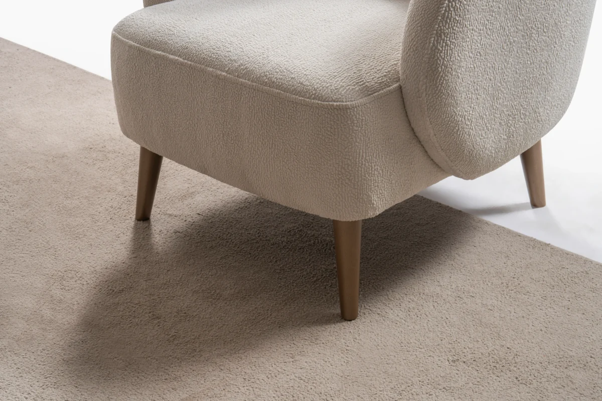 Laos Armchair - Minimalist rounded boucle accent chair with tapered wooden legs.