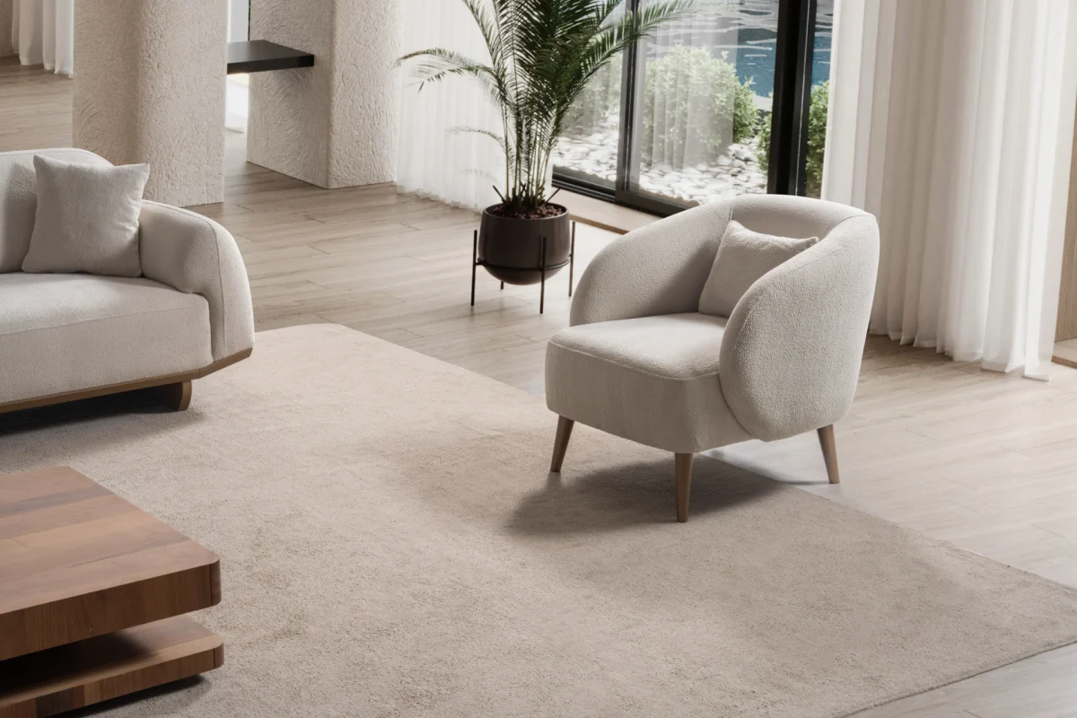 Laos Armchair - Minimalist rounded boucle accent chair with tapered wooden legs.