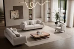 Laos Sofa Set by SofaTurkey featuring a modern rounded design in premium white boucle fabric, including two sofas and an armchair in a minimalist living room setting.