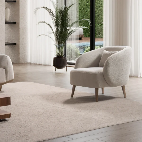 Laos Armchair - Minimalist rounded boucle accent chair with tapered wooden legs.