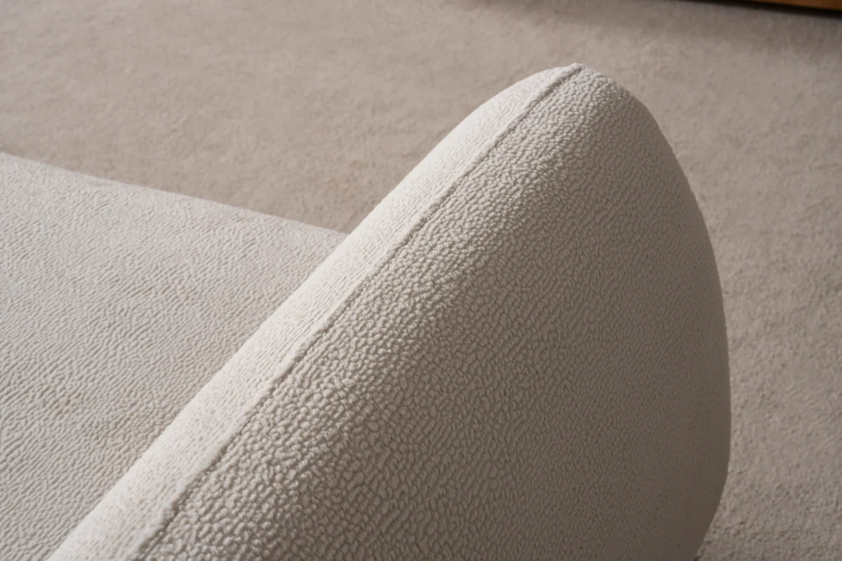 Modern rounded sofa with white boucle fabric and wooden base, luxury turkish furniture.