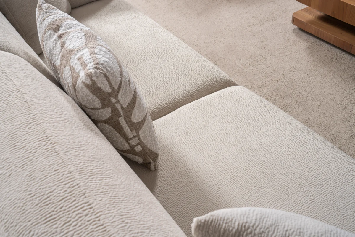 Modern rounded sofa with white boucle fabric and wooden base, luxury turkish furniture.