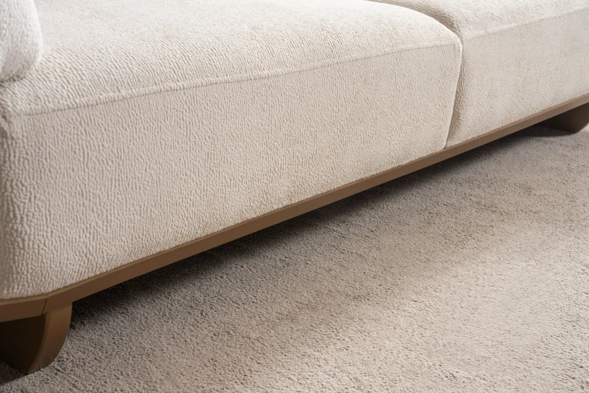 Modern rounded sofa with white boucle fabric and wooden base, luxury turkish furniture.