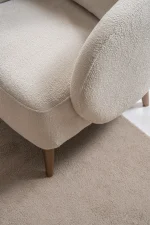 Laos Armchair - Minimalist rounded boucle accent chair with tapered wooden legs.